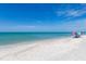 Relaxing beach scene with a couple under an umbrella, enjoying the ocean view at 15312 Spanish Point Dr, Port Charlotte, FL 33981