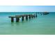 Old pier with weathered pilings extending into the sea at 15312 Spanish Point Dr, Port Charlotte, FL 33981