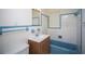 Clean bathroom with light blue accents, bathtub and sink at 1630 29Th St, Sarasota, FL 34234