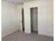 Bright bedroom with neutral walls, carpet, and double door closet at 1630 29Th St, Sarasota, FL 34234