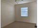 Cozy bedroom featuring neutral walls, carpeted floors, a modern ceiling fan and a window with blinds for soft, natural light at 1630 29Th St, Sarasota, FL 34234