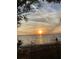 Picturesque sunset view over the water with silhouetted foliage in the foreground offering a serene coastal scene at 1630 29Th St, Sarasota, FL 34234