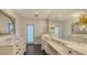 Spa-like bathroom with and sinks, a large mirror, and a walk-in shower at 1714 Irving St, Sarasota, FL 34236