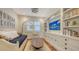 Cozy bedroom with built-in shelving, daybed, and hardwood floors at 1714 Irving St, Sarasota, FL 34236