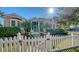 Two-story house with white picket fence, palm trees, and sunlit facade at 1714 Irving St, Sarasota, FL 34236
