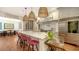Bright kitchen features marble island, pink barstools, and stainless appliances at 1714 Irving St, Sarasota, FL 34236