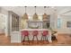Modern kitchen with marble island, pink barstools, and ample cabinet space at 1714 Irving St, Sarasota, FL 34236