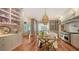 Open kitchen with marble island, bar cart, and hardwood floors at 1714 Irving St, Sarasota, FL 34236
