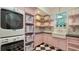 Laundry room with farmhouse sink and built-in shelving at 1714 Irving St, Sarasota, FL 34236