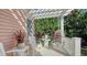 Charming patio with white chairs and a hanging egg chair at 1714 Irving St, Sarasota, FL 34236