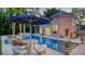 Beautiful pool area with outdoor seating and a view of the guesthouse at 1714 Irving St, Sarasota, FL 34236