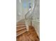 Elegant curved staircase with hardwood floors and white railing at 1714 Irving St, Sarasota, FL 34236
