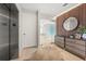 Modern entryway with stylish dresser and large mirror at 188 Golden Gate Pt # 202, Sarasota, FL 34236