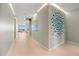 Bright hallway with light wood floors and modern art at 188 Golden Gate Pt # 202, Sarasota, FL 34236