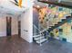 Stylish lobby with modern staircase and mosaic tile wall at 188 Golden Gate Pt # 202, Sarasota, FL 34236
