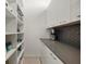 Bright and spacious pantry with ample shelving at 188 Golden Gate Pt # 202, Sarasota, FL 34236