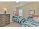 Twin bedroom with coastal decor and ample storage at 20223 Lagente Cir, Venice, FL 34293