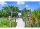 Beach access walkway with lush tropical foliage at 217 Malina Ct, Nokomis, FL 34275