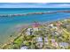 Aerial view showcasing waterfront property with lush landscaping and private dock at 2287 Bayshore Rd, Nokomis, FL 34275