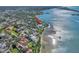 Aerial view of a waterfront home with a private dock and beautiful landscaping at 2287 Bayshore Rd, Nokomis, FL 34275