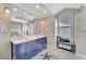 Bathroom with double vanity, blue cabinets, and a walk-in shower at 2287 Bayshore Rd, Nokomis, FL 34275