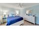 Bright bedroom with a queen bed, dresser and wood-look floors at 2287 Bayshore Rd, Nokomis, FL 34275