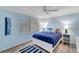 Cozy bedroom with a queen bed, light blue walls, and wood-look floors at 2287 Bayshore Rd, Nokomis, FL 34275