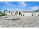 Modern white house with a gray paver driveway and attached garage at 2287 Bayshore Rd, Nokomis, FL 34275