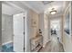 Bright hallway with wood-look floors and access to bedrooms and bath at 2287 Bayshore Rd, Nokomis, FL 34275