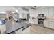 Modern kitchen with island, stainless steel appliances, and white cabinets at 2287 Bayshore Rd, Nokomis, FL 34275