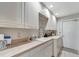 Laundry room with white cabinets, countertop, and a sink at 2287 Bayshore Rd, Nokomis, FL 34275