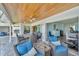 Spacious covered patio with seating area, overlooking a tranquil backyard at 2287 Bayshore Rd, Nokomis, FL 34275