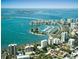 Aerial view of a coastal city with a marina and bridges at 4825 Gulf Of Mexico Dr # 304, Longboat Key, FL 34228