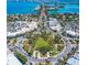 Aerial view of a vibrant town center with roundabouts and parking at 4825 Gulf Of Mexico Dr # 304, Longboat Key, FL 34228