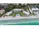 Aerial view of beachfront property with pool and tennis courts at 4825 Gulf Of Mexico Dr # 304, Longboat Key, FL 34228