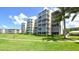 Condo building with lush landscaping at 4825 Gulf Of Mexico Dr # 304, Longboat Key, FL 34228