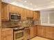Updated kitchen featuring stainless steel appliances and wood cabinets at 4825 Gulf Of Mexico Dr # 304, Longboat Key, FL 34228