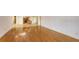 Spacious living area featuring hardwood floors and kitchen views at 4825 Gulf Of Mexico Dr # 304, Longboat Key, FL 34228