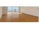 Living room with hardwood floors and balcony access at 4825 Gulf Of Mexico Dr # 304, Longboat Key, FL 34228