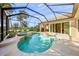 Gorgeous screened-in pool and spa with a waterfall feature and patio area at 518 Luminary Blvd, Osprey, FL 34229