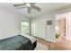 Bright bedroom with a ceiling fan and access to another room at 606 19Th W Ave, Palmetto, FL 34221