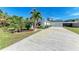 Long driveway leading to a white house with garage at 606 19Th W Ave, Palmetto, FL 34221