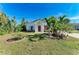 Landscaped yard with palm trees and a white house at 606 19Th W Ave, Palmetto, FL 34221