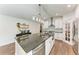 Modern kitchen with granite island, white cabinets, and stainless steel appliances at 606 19Th W Ave, Palmetto, FL 34221