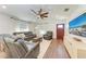 Living room with reclining couches, hardwood floors, and TV at 606 19Th W Ave, Palmetto, FL 34221