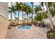 Private pool area with patio furniture and tropical landscaping at 7000 Marina Dr, Holmes Beach, FL 34217