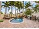 Inviting kidney-shaped pool with patio and tropical landscaping at 7000 Marina Dr, Holmes Beach, FL 34217