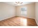 Light-filled bedroom featuring wood floors at 8026 Barberry Dr, Port Richey, FL 34668