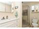 Clean bathroom with shower, toilet and white vanity at 932 Capri Isles Blvd # 216, Venice, FL 34292