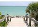 Wooden walkway leading to a pristine sandy beach at 932 Capri Isles Blvd # 216, Venice, FL 34292